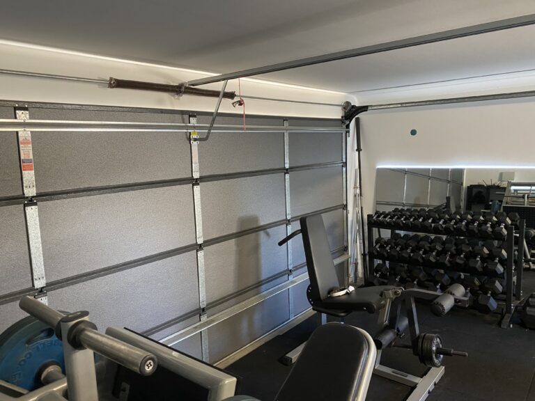 Customer installation of ThermaDoor graphite DIY garage door insulation kit on a sectional garage door