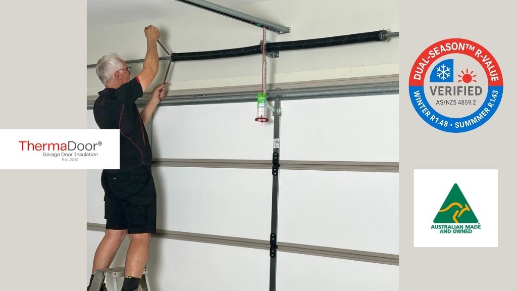 Peter Hinton installing ThermaDoor® Premium garage door insulation and perimeter seals, performing professional spring adjustment as part of a compliant AS 3999 and AS/NZS 4505 installation. Australian-made, dual-season R-value verified insulation panels (R1.48 winter / R1.43 summer).