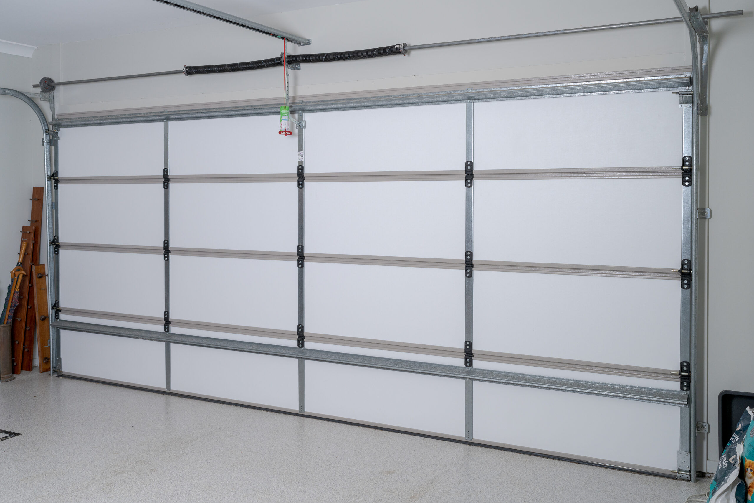 Garage door insulation installed on a sectional garage door, showing internal panels and structure used when comparing insulation options