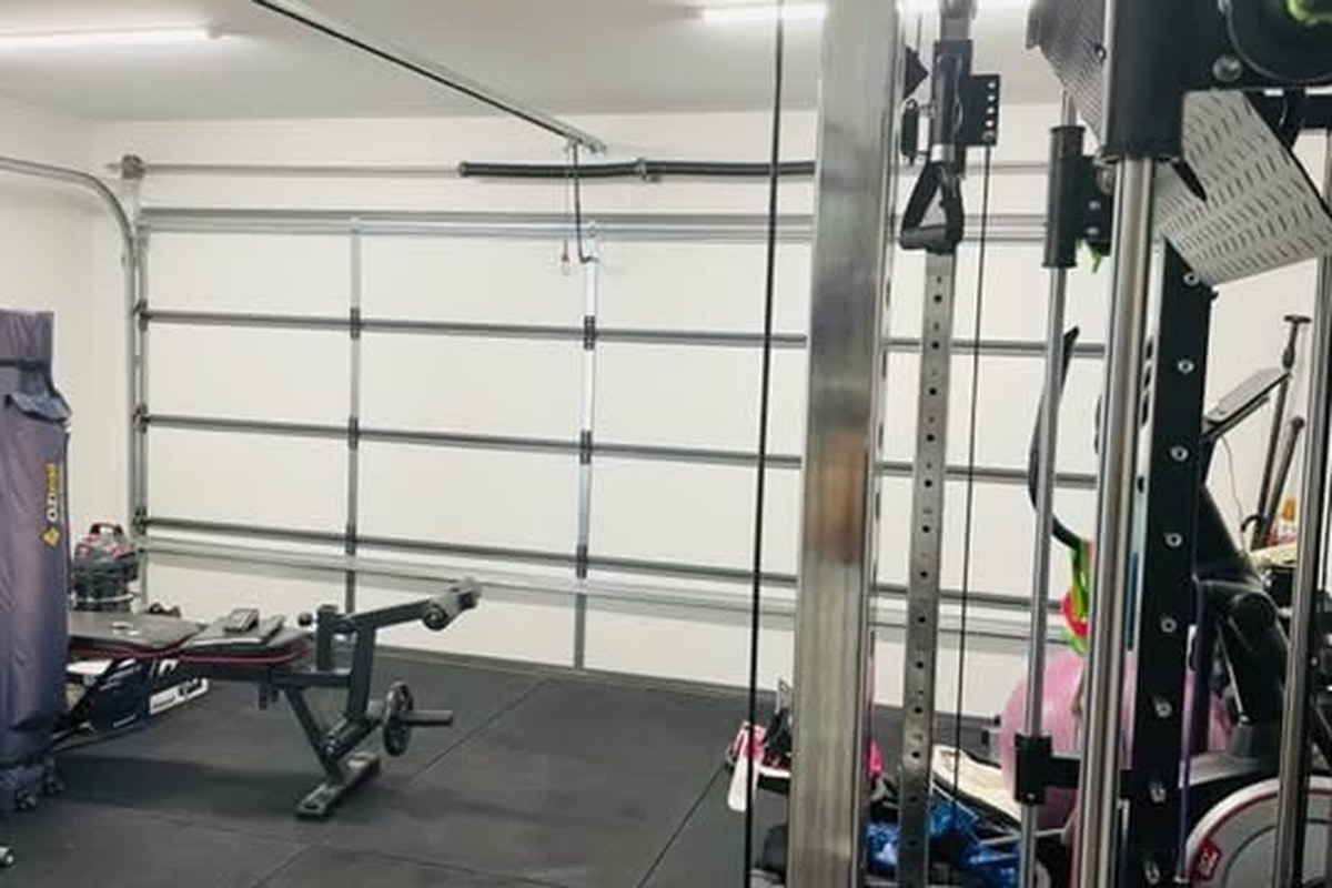 Insulated garage converted into a home gym with ThermaDoor garage door insulation