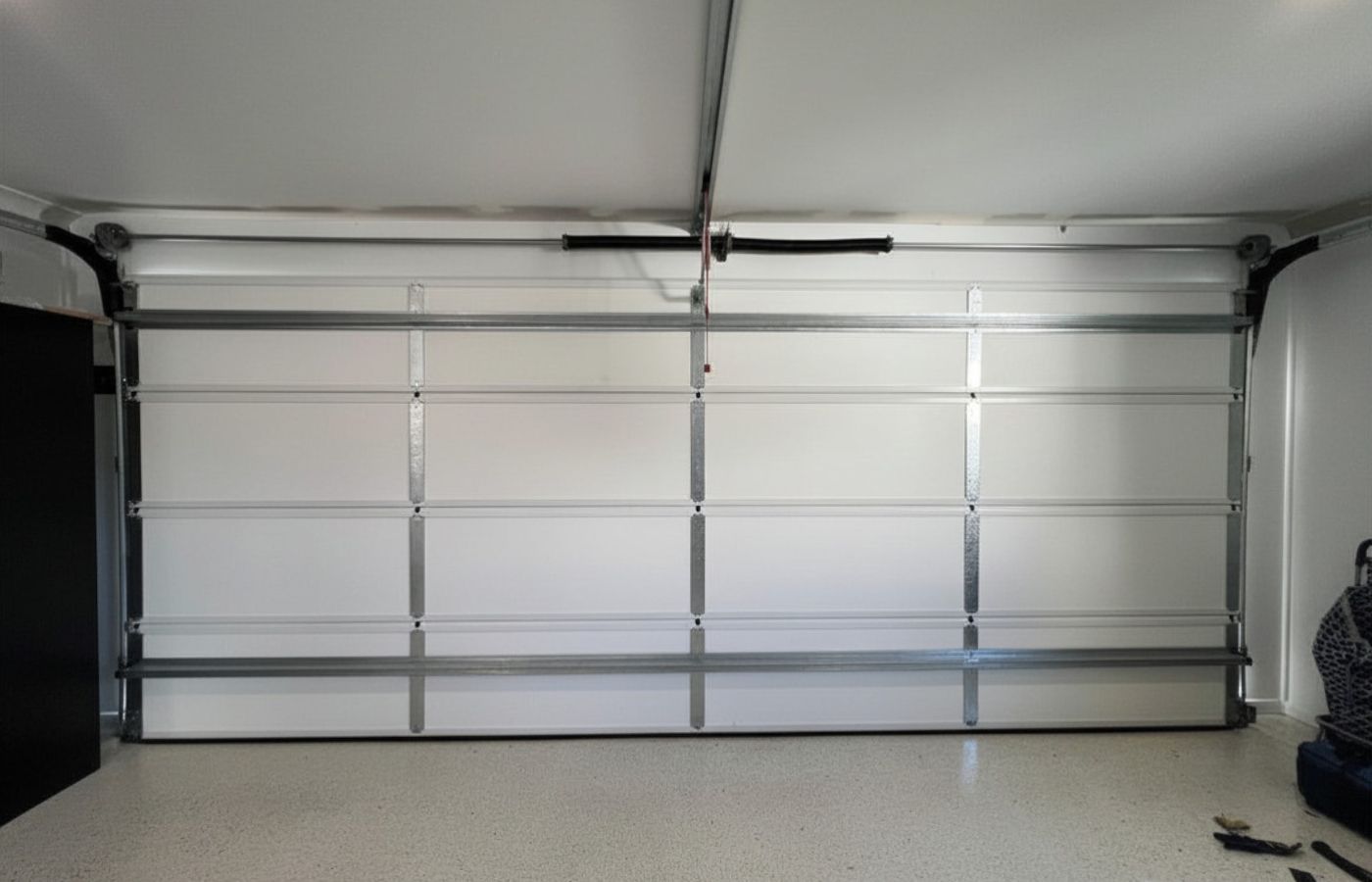 ThermaDoor insulated garage door panels installed on a west-facing sectional garage door at a residential property in Mountain Creek Queensland showing white vinyl panels and epoxy floor