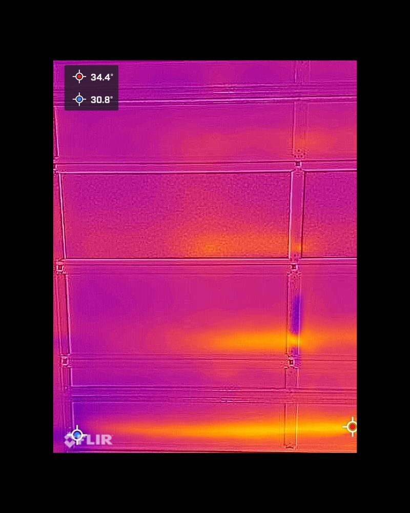 FLIR thermal image showing ThermaDoor insulated garage door surface temperature at 30.8 degrees Celsius, down from 44.7 degrees before installation, Mountain Creek Queensland