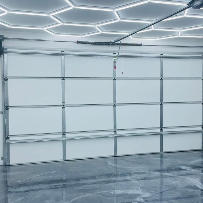 Premium garage with ThermaDoor insulation panels and hexagonal LED ceiling lighting
