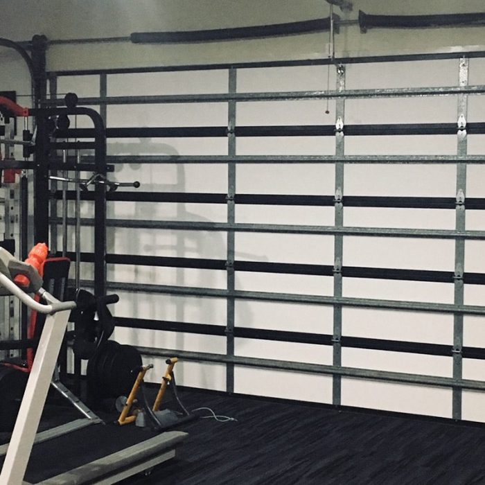 Garage converted into a home gym with ThermaDoor insulation panels on the door